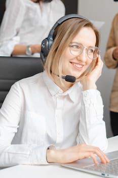 Don't Wait Any Longer. Call Today for a Free Consult! Professional woman in headset offering customer support at a call center.