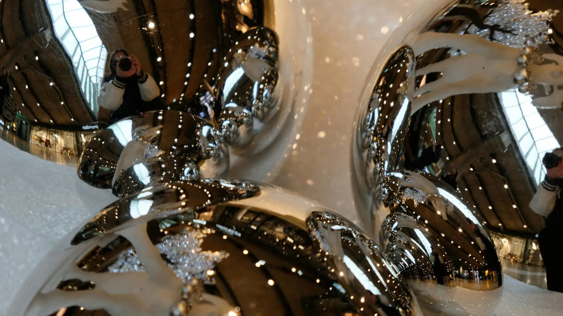 From above of silver glimmering sphere shaped baubles prepared for decorating and celebrating Christmas